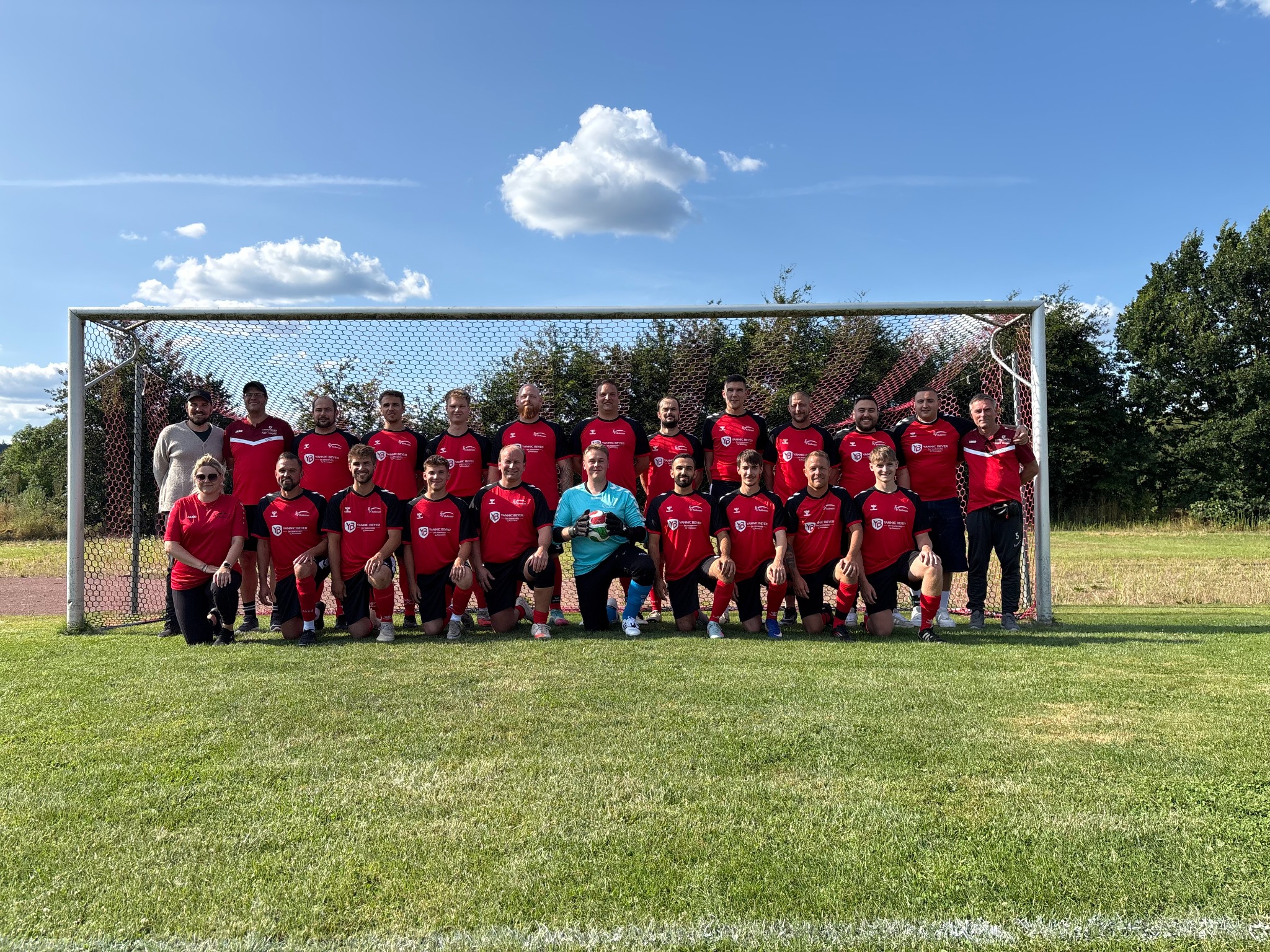 Die Mannschaft des TSV Bollensen in roten Trikots mit Yannic-Beyer-Sponsoring